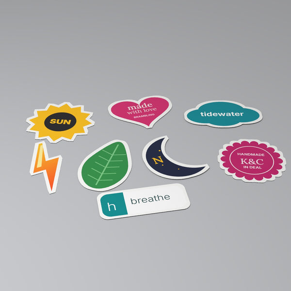 Custom die-cut stickers in shapes including sun, heart, cloud, leaf, moon and scalloped badge